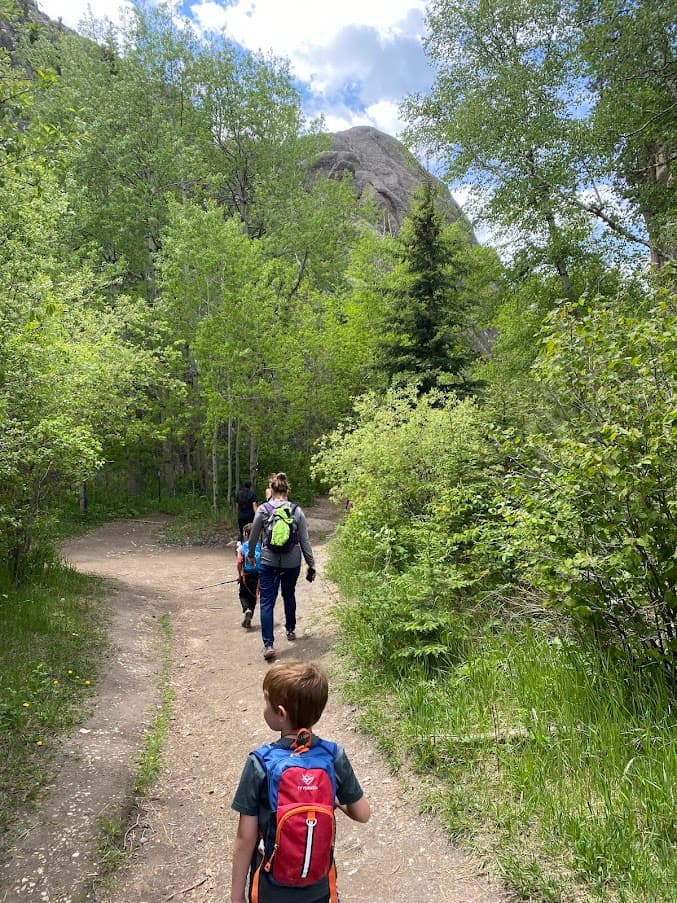A family hiking together on a wooded trail